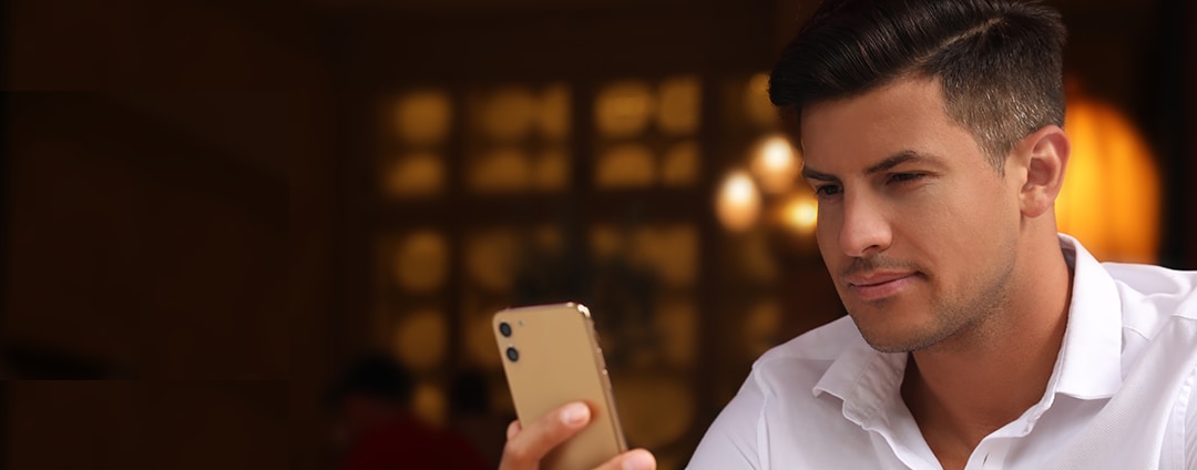 A business owner checking his business banking mobile app